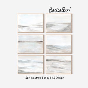 May include: Six framed abstract landscape art prints in neutral tones of white, gray, and beige. The artwork features soft, blurred lines and a minimalist style. The text "Bestseller!" is in the upper right corner. The text "Soft Neutrals Set by NLS Design" is at the bottom.