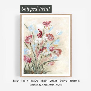 May include: A framed floral print with a bouquet of red, white, and blue flowers on a beige backdrop. The artwork is in a wooden frame and includes the text "Shipped Print". Print sizes range from 20.32 x 25.4 cm to 101.6 x 152.4 cm.