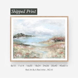 May include: A framed landscape painting with a light wood frame. The artwork depicts a coastal scene with a light blue body of water, a cloudy sky, and muted tones of green, pink, and brown. Text at the top reads "Shipped Print". Sizes available: 8x10 to 40x60 inches.