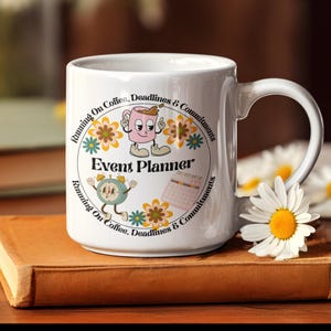 May include: White ceramic mug with a colorful design featuring a cartoon coffee cup, a clock, and a calendar. The text "Running On Coffee, Deadlines & Commitments" is written around the design. The text "Event Planner" is written in the center of the design.