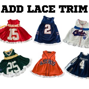 May include: Collection of six children's dresses designed to resemble sports jerseys. Each dress features team colors, numbers, and logos, with lace trim at the hem. The text "ADD LACE TRIM" is displayed at the top.