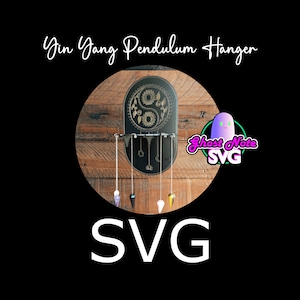 May include: Black Yin Yang pendulum hanger with a decorative design and hanging pendulums. The hanger is mounted on a wooden background. The pendulums are various colors and shapes. The word "SVG" is at the bottom.