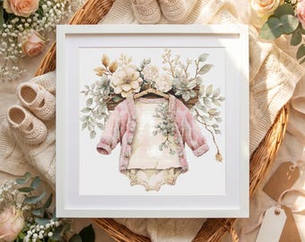 Op de afbeelding: Een ingelijste aquarelprint met een babyoutfit, waaronder een roze vest en een romper, versierd met bloemstukken. Het kunstwerk is geplaatst tegen een neutrale achtergrond, met babyschoentjes en labels die bij het thema passen. De algehele esthetiek is zacht en delicaat.