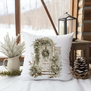 May include: White square throw pillow featuring a watercolor illustration of a vintage door adorned with a wreath and climbing greenery. The pillow is placed on a white surface, with a winter scene visible through a window in the background.