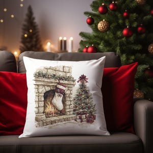 May include: A white throw pillow with a Christmas scene featuring a fireplace, stocking, and decorated tree. The pillow is on a gray couch with red pillows and a Christmas tree in the background.