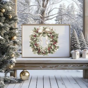 May include: A framed print of a Christmas wreath with red berries, green leaves, and a cream-colored bow. The print is displayed on a wooden bench with miniature Christmas trees and wrapped gifts. A Christmas tree with gold ornaments is on the left.