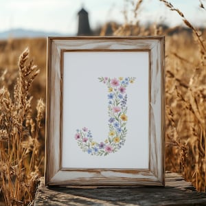 May include: A white ceramic mug with a black handle and the text "But First, Coffee" in a black, bold font. The mug is on a white surface.