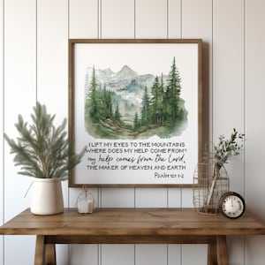 May include: A watercolor painting of a mountain landscape with a quote from Psalm 121:1-2, "I lift my eyes to the mountains, where does my help come from? My help comes from the Lord, the maker of heaven and earth."
