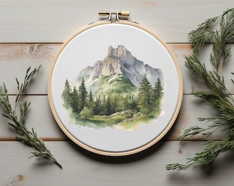 May include: A watercolor painting of a mountain range with a forest in the foreground. The painting is framed in a wooden embroidery hoop.