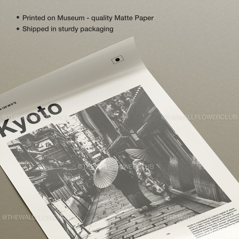 May include: Black and white photograph of a narrow street in Kyoto, Japan. The street is lined with traditional Japanese buildings and a person is walking down the street with an umbrella.