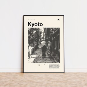 May include: Black and white photograph of a narrow street in Kyoto, Japan. Two people walk down the street, each holding a traditional Japanese umbrella. The text "Kyoto" is printed in bold at the top of the image.
