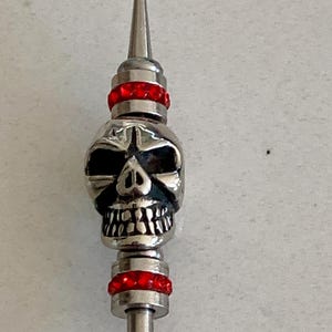 Stainless-steel skull hair stick/pin with two red rhinestone beads