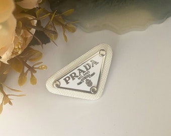 prada logo brooch