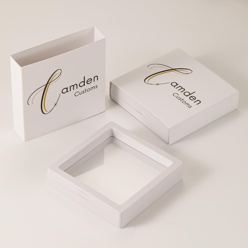 May include: Three white boxes with a clear plastic window. The boxes are labeled "Camden Customs" with a stylized "C" logo.