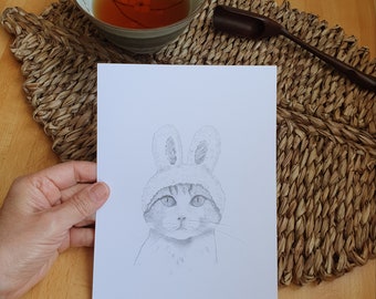 Original and unique graphite pencil drawing of a cute kitten dressed as a rabbit. Drawing to decorate your home or to offer.