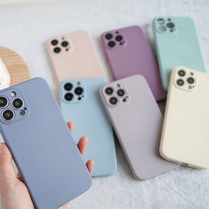 May include: A set of 7 silicone phone cases in various pastel colours. The cases have a raised camera bump and a smooth, matte finish.
