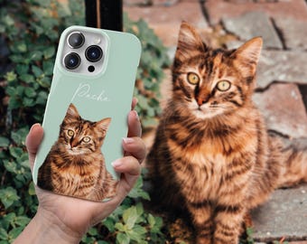 May include: A mint green phone case with a photo of a brown tabby cat on it. The cat's name, "Pacha", is written in white cursive on the case.