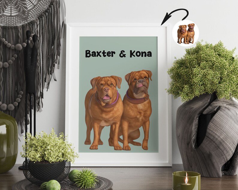 K&ouml;nnte beinhalten: Ein wei&szlig;er gerahmter Druck mit hellgr&uuml;nem Hintergrund, auf dem zwei braune Hunde zu sehen sind. Die Hunde hei&szlig;en Baxter & Kona. Der Druck h&auml;ngt an einer wei&szlig;en Wand.