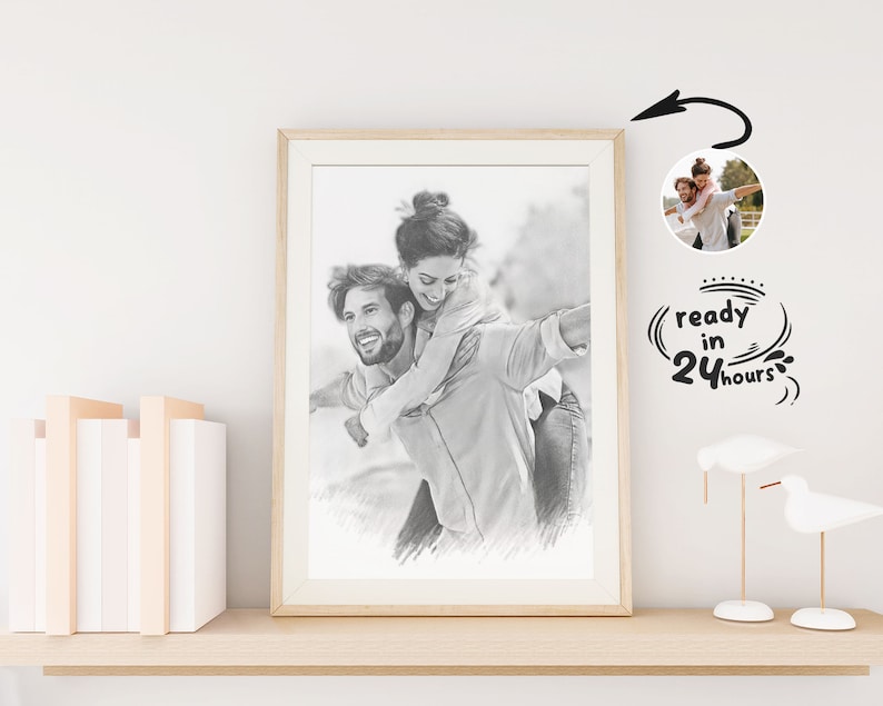 May include: A black and white pencil drawing of a couple, a man and a woman, smiling and looking at each other. The woman is on the man's back, and they are both holding onto each other. The drawing is framed in a light wood frame and is hanging on a white wall. The text "ready in 24 hours" is written in a circle around a smaller image of the couple.
