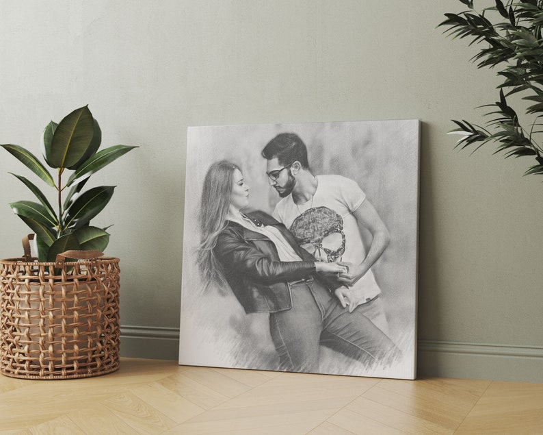 May include: Black and white pencil drawing of a couple dancing. The woman is wearing a black leather jacket and the man is wearing a white t-shirt with a skull design.