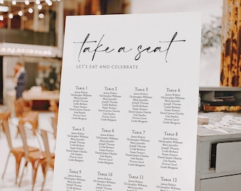 May include: A white seating chart with black text for a wedding reception. The chart is titled "Take a Seat" and lists the names of guests at each table. The tables are numbered 1 through 12.