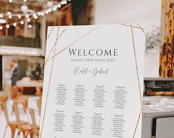 May include: A white wedding seating chart with gold geometric lines and glitter accents. The chart lists guest names by table number. The text at the top reads "Welcome, Please Find Your Seat, Rubel + Gabriel".