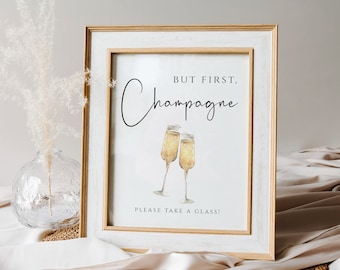 May include: A framed printable sign with the text "But first, Champagne" and a watercolor illustration of two champagne flutes. The sign also includes the text "Please take a glass!"