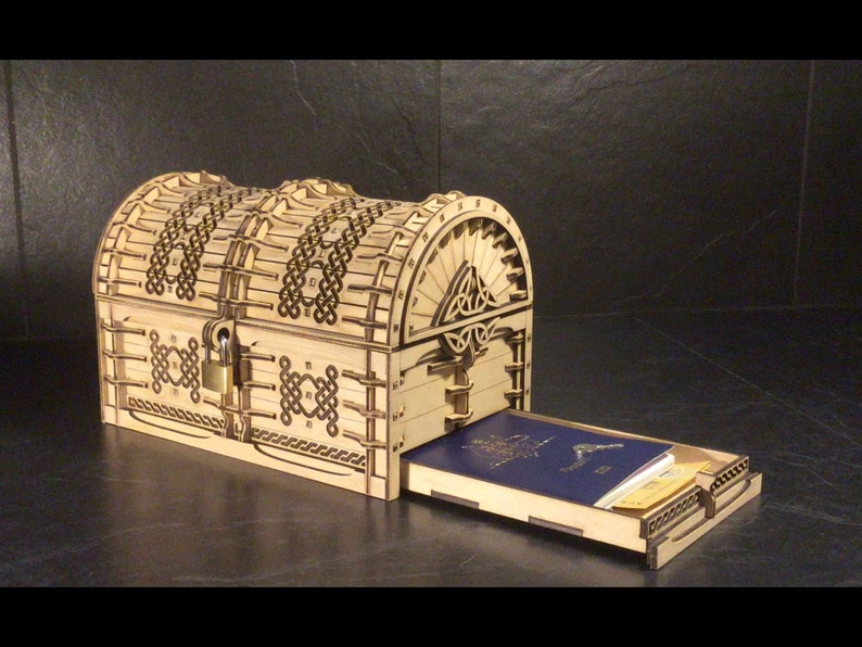 May include: A wooden treasure chest with intricate Celtic knotwork designs. The chest is open, revealing a blue passport and other items inside.