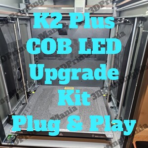 May include: A close-up of a 3D printer with a black and gray build plate. The printer is labeled "K2 Plus COB LED Upgrade Kit Plug & Play".