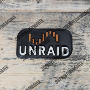 May include: A black and orange 3D printed sticker with the word "UNRAID" in white letters. The sticker has a graphic of a bar chart with orange bars.