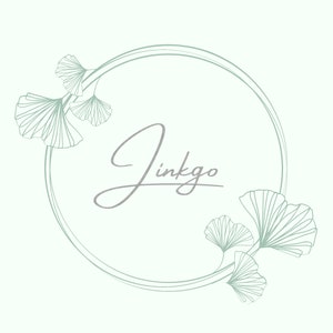 May include: A circular frame with a delicate, light green outline. The word "Ginkgo" is written in a cursive font inside the frame. The frame is decorated with stylized ginkgo leaves on either side.
