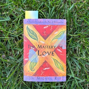 The mastery of love book with a gradient bookmark inside.