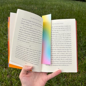 A gradient bookmark inside of a don miguel ruiz book.