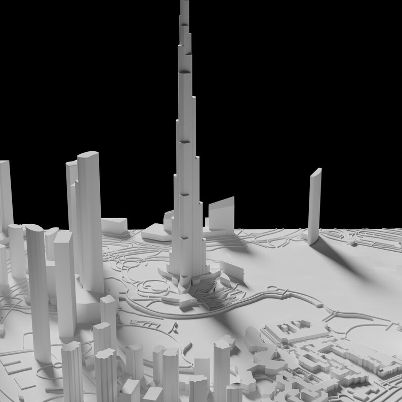 Puede incluir: Un modelo blanco de un horizonte de ciudad con un rascacielos alto en el centro. El modelo est&aacute; hecho de papel o cart&oacute;n y se coloca sobre un fondo negro.