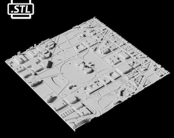 Op de afbeelding: Een 3D-geprint model van een stad met gebouwen en straten. Het model is geprint in wit plastic en is ongeveer 25 cm breed.