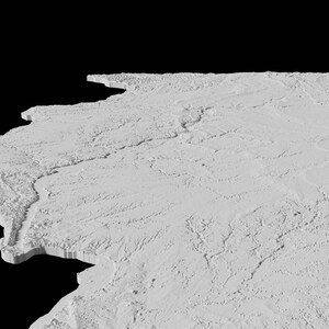 May include: A 3D printed model of a landscape with a river running through it. The model is made of white plastic and has a textured surface.