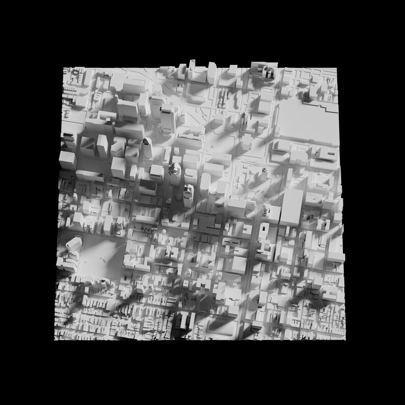 May include: A white 3D model of a city with tall buildings and streets. The model is lit from the top, casting shadows on the buildings and streets.