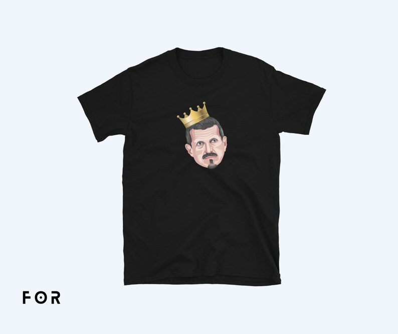 May include: Black t-shirt with a cartoon illustration of a man wearing a gold crown.