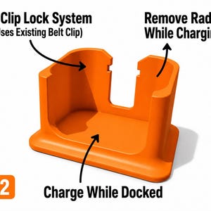 May include: An orange radio charging dock with the text "V2 Clip Lock System" and "Charge While Docked". The dock uses the existing belt clip and allows the radio to be removed while charging.