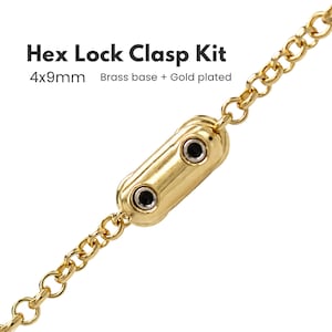 Puede incluir: Un kit de cierre hex lock de latón chapado en oro de 4x9mm, con un cierre cilíndrico dorado con dos acentos circulares negros unido a una cadena dorada. El texto Hex Lock Clasp Kit 4x9mm Brass base + Gold plated es visible arriba.
