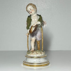 Antique MEiSSEN Porcelain Figurine Cupid As A Beggar First Sorting. Crossed Swords 22 cm