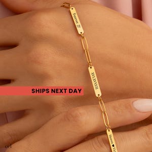 May include: A gold-toned chain bracelet featuring alternating oval links and rectangular metal bars. The bars are engraved with the text Forever with a bird icon, the Roman numerals XVI.XV.XVII, and the text Heaven followed by a heart icon.