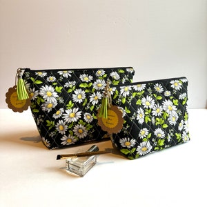 Black cotton quilt makeup bag with white daisies; fabric zippered cosmetic bag with lining and tassel; sturdy multipurpose zippered pouch