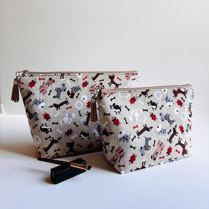 Beige doggie print zippered cotton makeup bag; brown multipurpose pouch with dog print; zippered fabric storage pouch; travel pouch