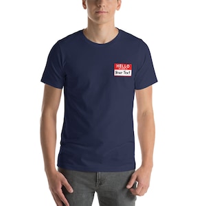 May include: A navy blue t-shirt with a red name tag that says "HELLO MY NAME IS Your Text".