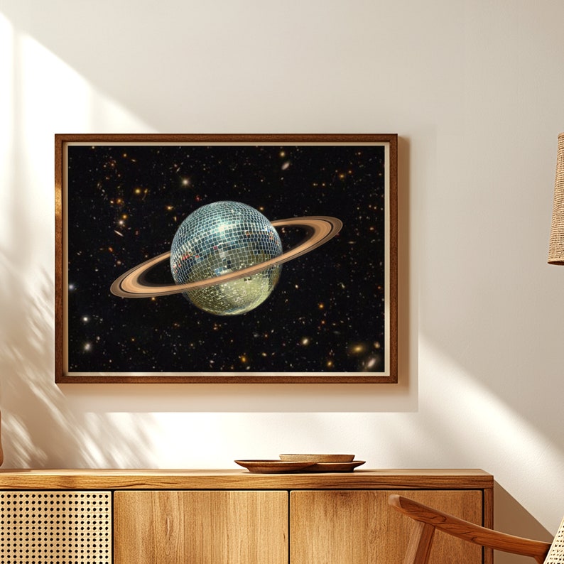 May include: A disco ball planet with a ring system against a black background with stars.