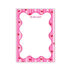 May include: Pink and white striped to-do list notepad with a white scalloped border and red hearts.
