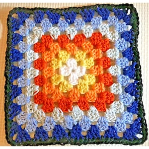 Puede incluir: Un cuadrado de ganchillo hecho a mano con una paleta de colores vibrantes. El centro es blanco, pasando a amarillo, naranja y luego azul. El borde exterior es verde oscuro, creando un borde definido. La pieza es probablemente un posavasos o un pequeño objeto decorativo.