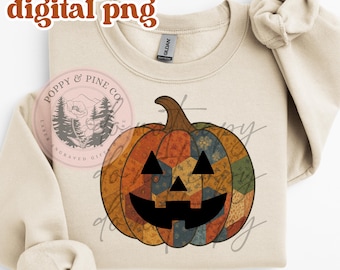 May include: A beige sweatshirt featuring a patchwork pumpkin design with a black face. The pumpkin is in shades of orange, blue, and green. The words "digital png" are in the upper left corner. The brand logo is on the left side.
