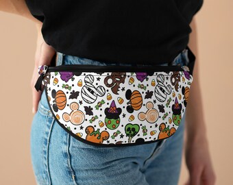 May include: A white fanny pack with a black trim and a Halloween-themed print featuring Mickey Mouse, pumpkins, candy corn, and bats.